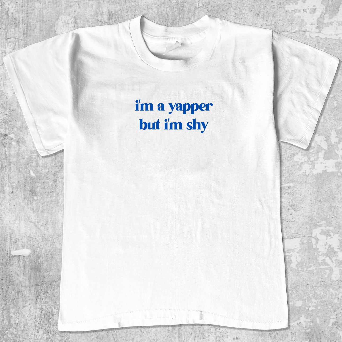 I'm A Yapper But I'm Shy graphic tee with bold and humorous print, funny and trendy graphic. Perfect gifts for friends and family. White shirt.