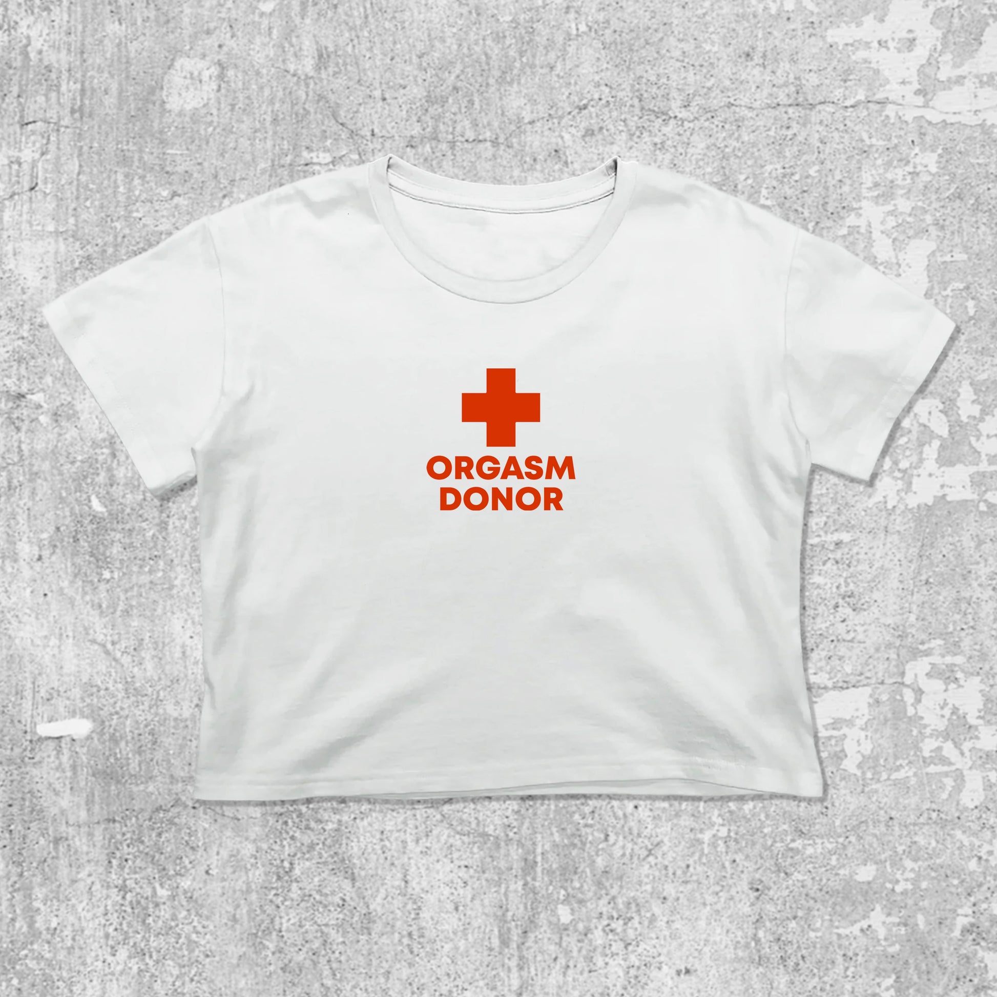 Orgasm Donor graphic crop tee with cute and trendy fit, featuring playful vintage graphic, stylish cut. White crop t-shirt