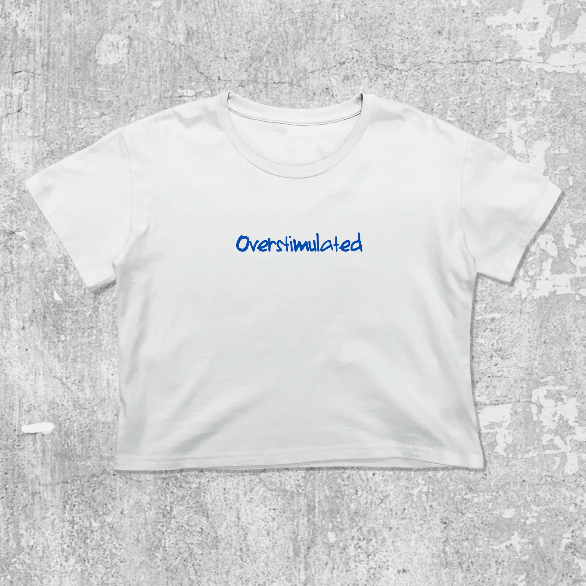 Overstimulated graphic crop tee with cute and trendy fit, featuring playful vintage graphic, stylish cut. White crop t-shirt