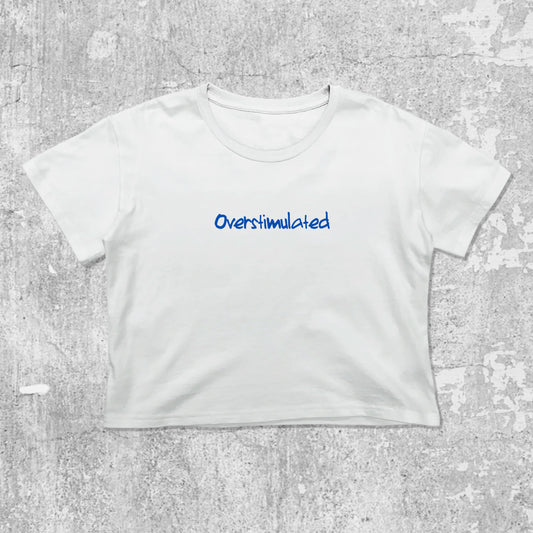 Overstimulated graphic crop tee with cute and trendy fit, featuring playful vintage graphic, stylish cut. White crop t-shirt