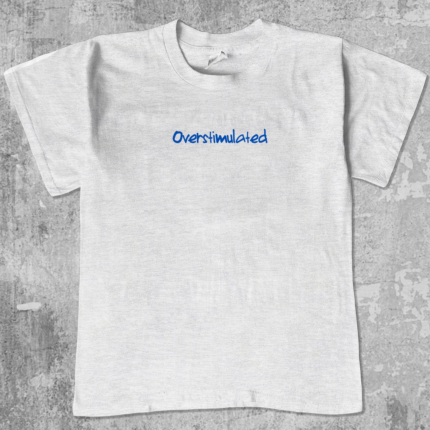 Overstimulated graphic tee with bold and humorous print, funny and trendy graphic. Perfect gifts for friends and family. Ash Grey shirt.