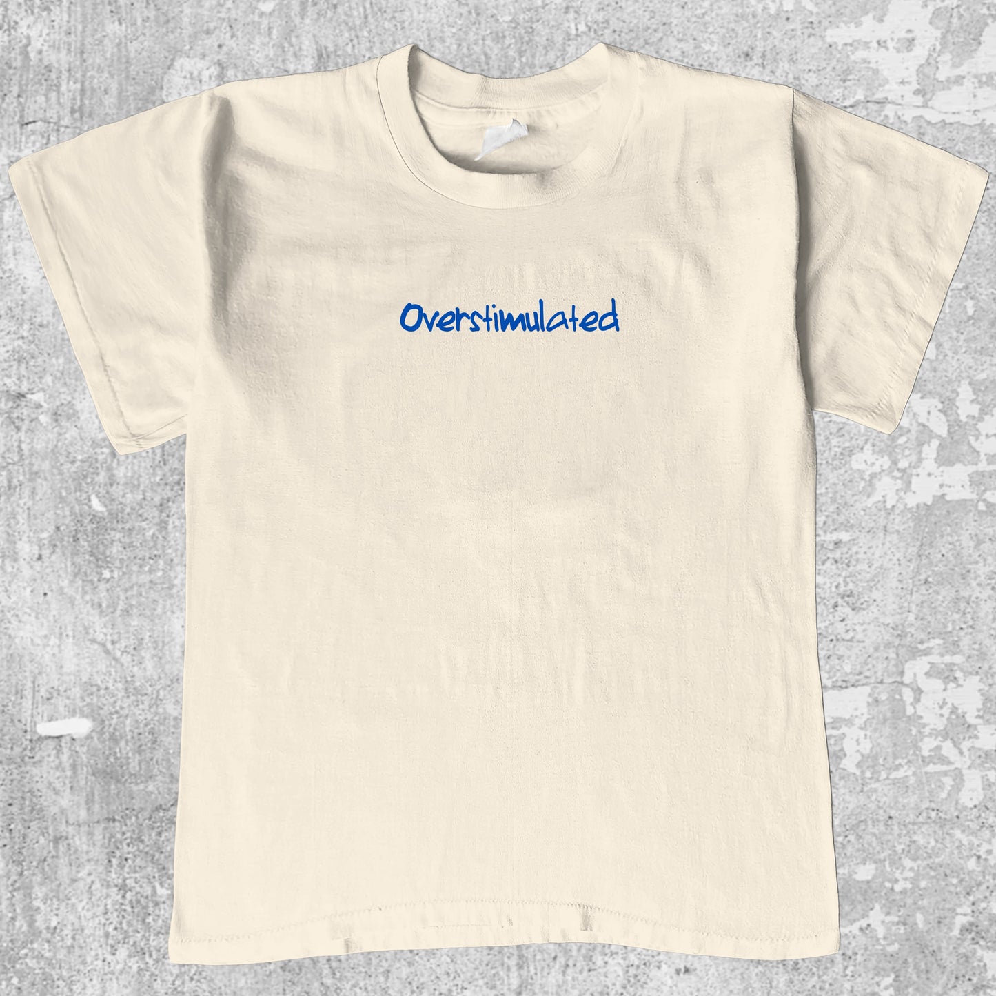 Overstimulated graphic tee with bold and humorous print, funny and trendy graphic. Perfect gifts for friends and family. Cream shirt.