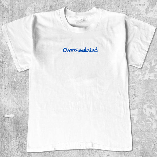 Overstimulated graphic tee with bold and humorous print, funny and trendy graphic. Perfect gifts for friends and family. White shirt.