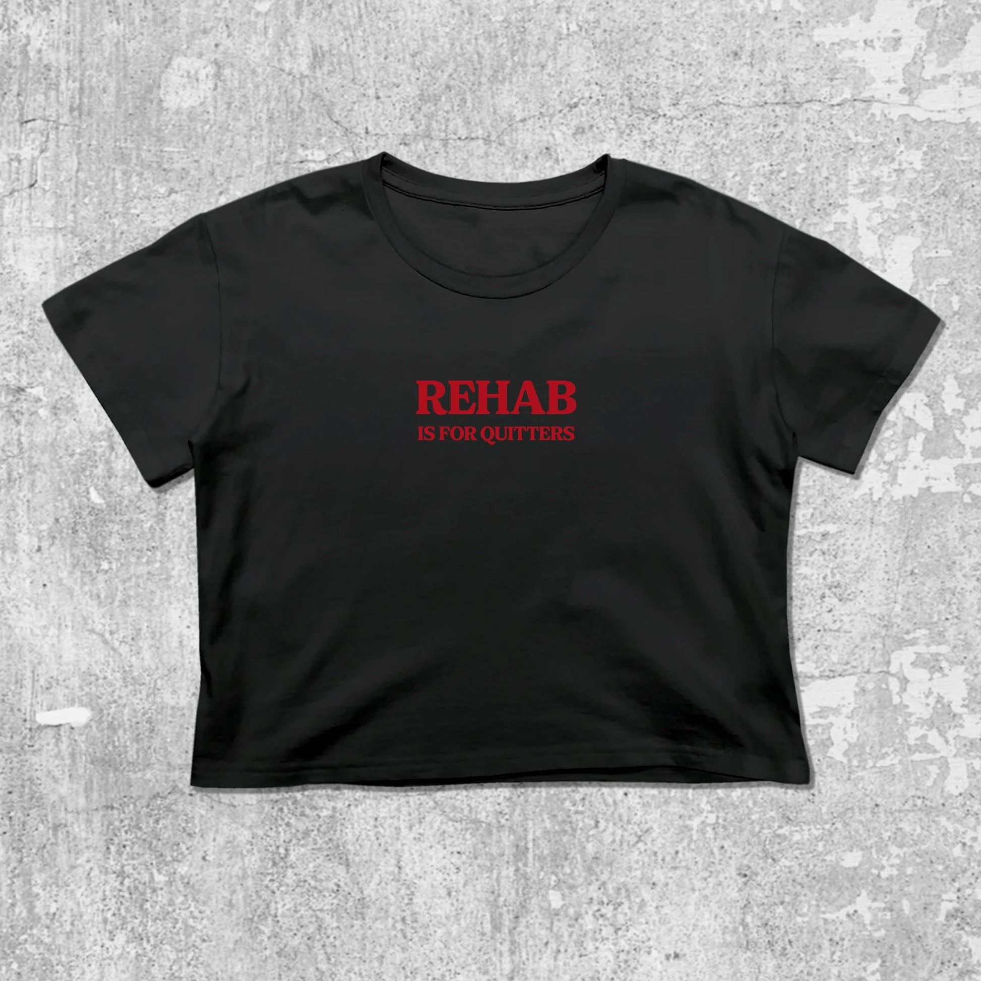 Rehab Is For Quitters graphic crop tee with cute and trendy fit, featuring playful vintage graphic, stylish cut. Black crop t-shirt
