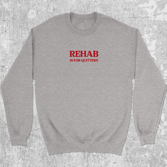 Rehab Is For Quitters graphic sweatshirt with bold and humorous print, warm and cozy graphic for everyday wear. Perfect funny gift for Christmas. Heather Grey pullover.