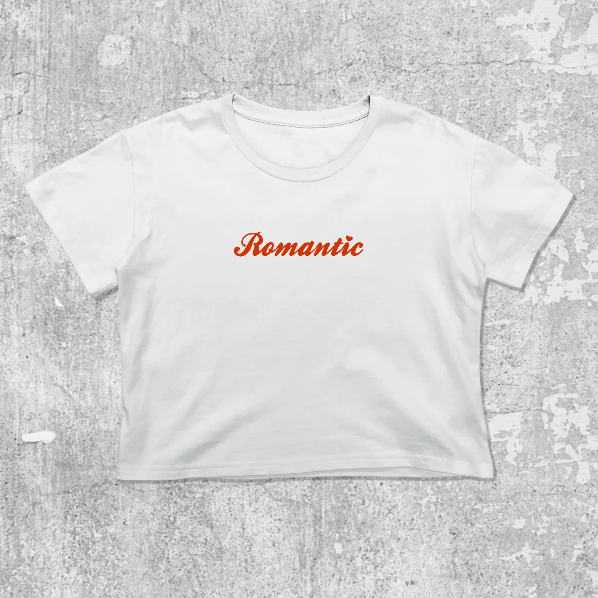 Romantic graphic crop tee with cute and trendy fit, featuring playful vintage graphic, stylish cut. White crop t-shirt