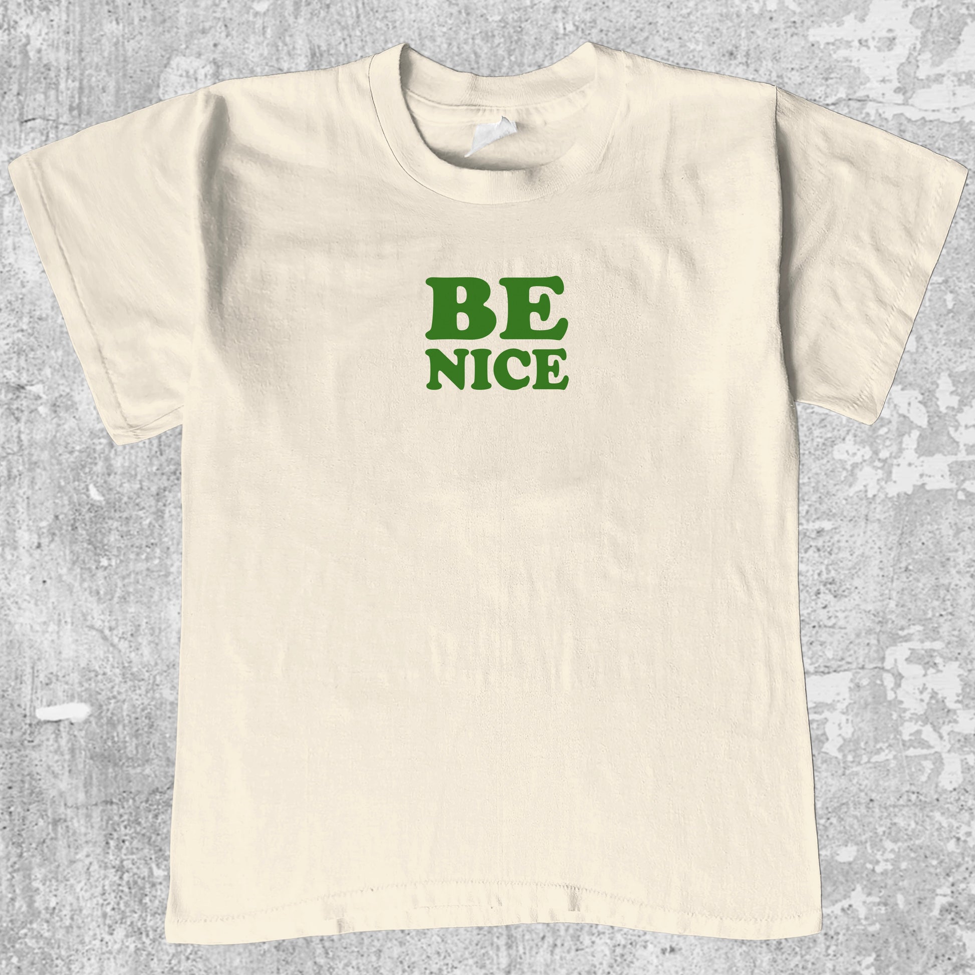 Be Nice graphic tee with bold and humorous print, funny and trendy graphic. Perfect for adults and gift-giving. Cream shirt.
