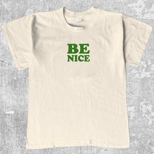 Be Nice graphic tee with bold and humorous print, funny and trendy graphic. Perfect for adults and gift-giving. Cream shirt.