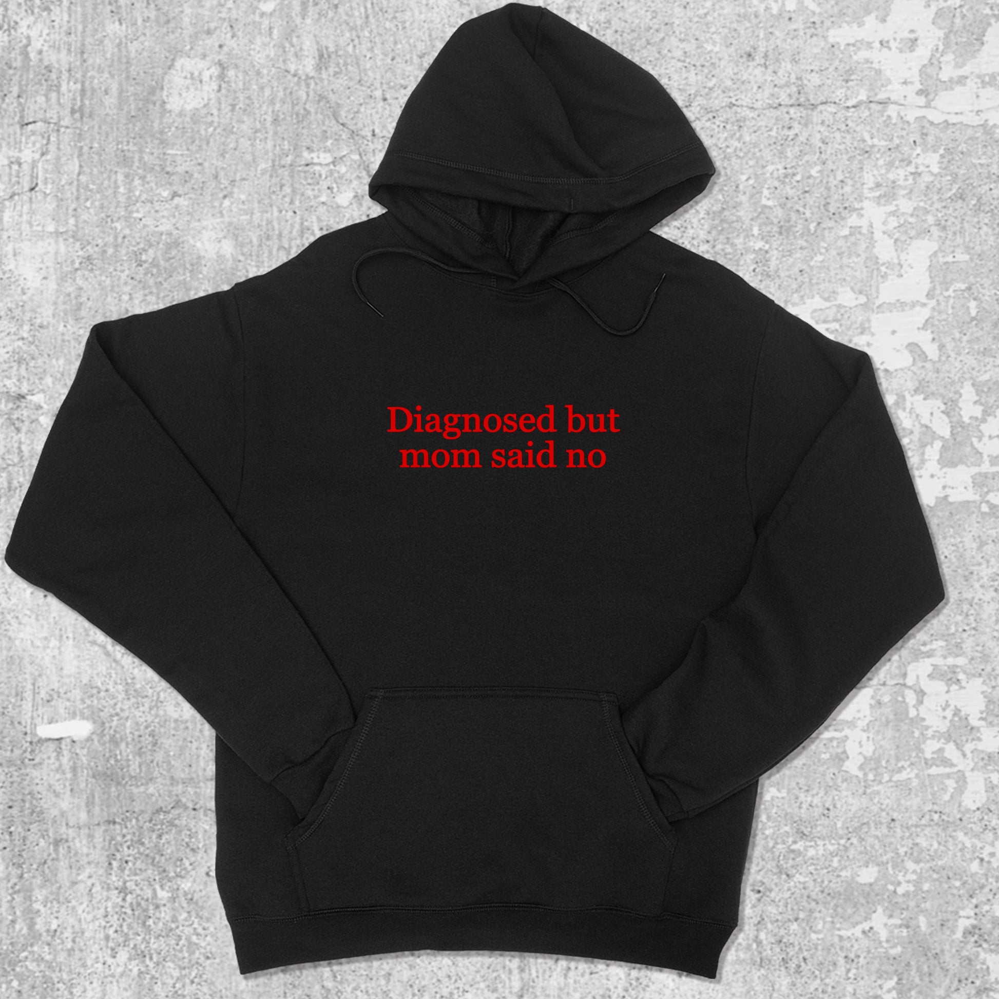Diagnosed But Mom Said No graphic hoodie with funny and trendy artwork, casual streetwear with bold personality. Great for adults and gifting. Black hoodie.