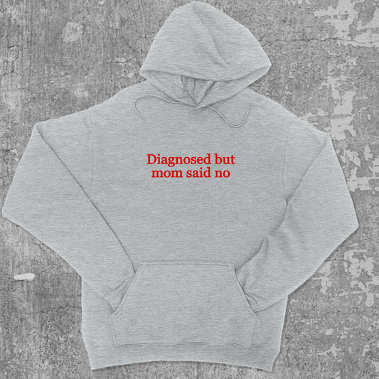 Diagnosed But Mom Said No graphic hoodie with funny and trendy artwork, casual streetwear with bold personality. Great for adults and gifting. Heather Grey hoodie.
